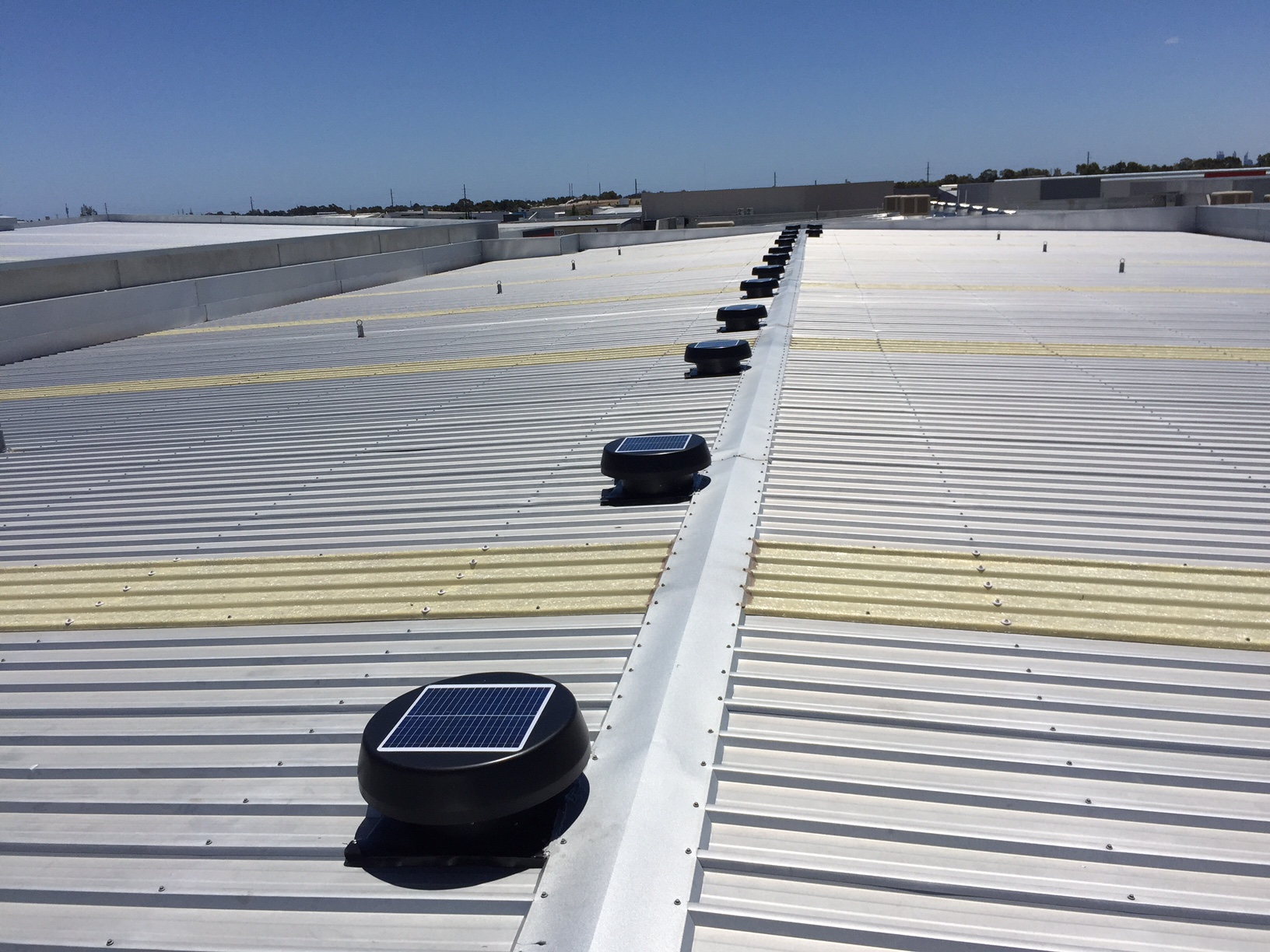 Solar-powered roof ventilator installation for improved air circulation and heat extraction